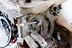 Metal industry stand with drill machine. Home workshop with hard tools on the metal stand. Old rusty hand tool drill