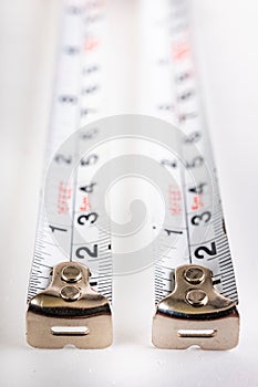 Metal joinery measures on a white table. Accessories for production workers