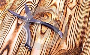 Metal kitchen scissors on a wooden table