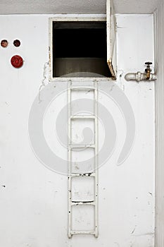 Metal ladder for climbing to the hatch of an apartment