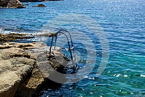 The metal ladder for the descent into the sea