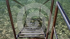 Metal ladder to descend to the water at sea