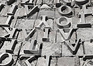 Metal letters of the Greek alphabet on a gray stone surface background