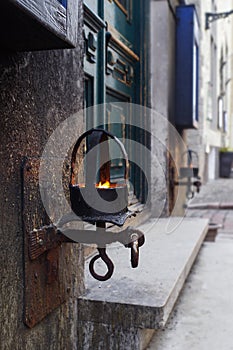 A metal lit lantern with burning fire light