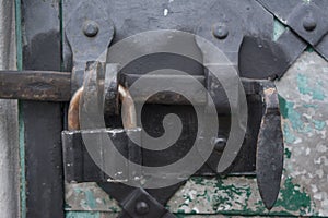 Metal lock on door into the ancient trinity christian ortodox church