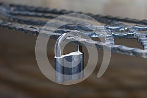 Metal lock, latched on a metal decorative forged lattice.