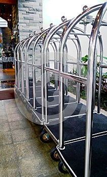 Metal Luggage Carts Lined Up in front of Lobby hotel