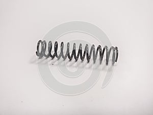 Metal mainspring on a white background