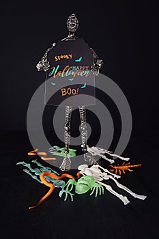 Metal mannequin holding Halloween sign