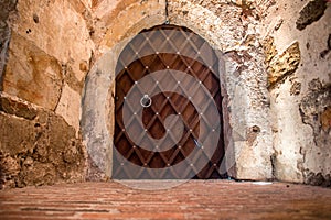 Metal massive door in a stone cave