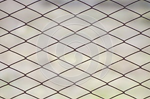 Metal mesh against soft background. Close-up of rusty seamless mesh