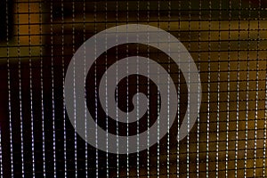 Metal mesh in the dark. The texture of the grille at night. Fence made of steel