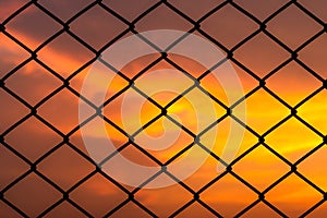 Metal mesh pattern with dramatic sky background