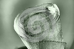 Metal mesh. Rolled mesh in gray. Heavy duty steel or aluminum mesh with ragged edges.