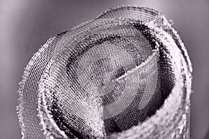 Metal mesh. Rolled mesh in gray. Heavy duty steel or aluminum mesh with ragged edges.