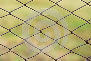 Metal mesh with traces of corrosion close-up on a natural background. Abstract background with repeating elements