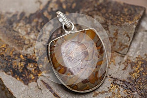 metal mineral stone pendant on rocky background