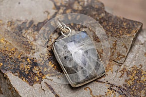 metal mineral stone pendant on rocky background