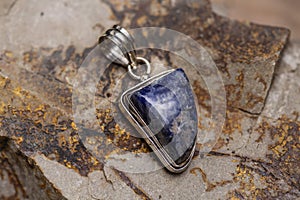 metal mineral stone pendant on rocky background