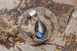 metal mineral stone pendant on rocky background