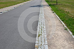 Metal modern park bench with a metal lightening structure on one leg stands in the park in rest areas and on roads made of