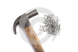 Metal nails and a hammer isolated on a white background