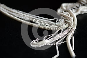 Metal necklace tied in a knot on a dark background