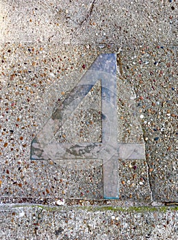 Metal Number Four in Pavement