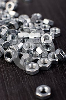 Metal nuts background. Macro. Working tools. Fixing elements.