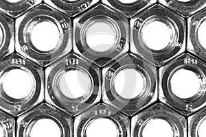 Metal nuts in a row background. Chromed screw nuts . Steel nuts pattern. Set of Nuts and bolts. Tools for work. Black and