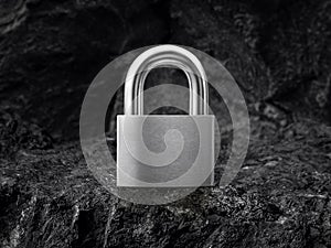 Metal padlock on black coal background
