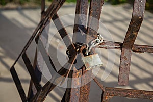 Metal Padlock and Chain attached to Rusty Railings