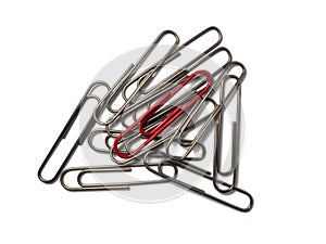 Metal paper clips on a white background. Office supplies isolate. Idea. The concept of loneliness. Confrontation. Stands out from