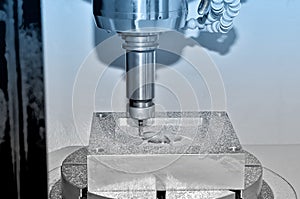 Metal part on an industrial milling machine. Blue toning