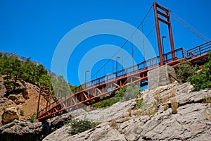 Metal pedestrian bridge over the gorge and mountain river. Yerkopru waterfall, Ermenek river, Mersin province,Turkey