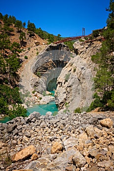 Metal pedestrian bridge over the gorge and mountain river. Yerkopru waterfall, Ermenek river, Mersin province,Turkey