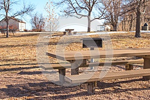 A metal picnic table and BBQ grill at a picnic area near Denver, Colorado.