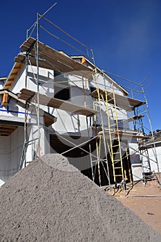 Metal pipe scaffolding and sandpile on new housing project