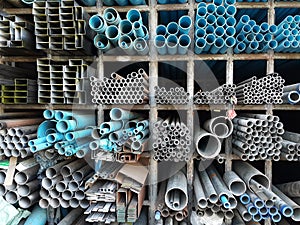 Metal pipes and pvc pipes stack on shelf