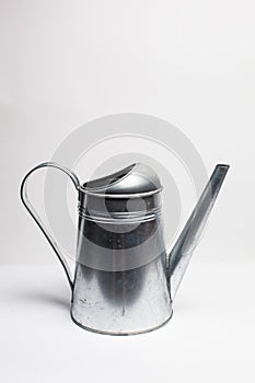 Metal pitcher over white