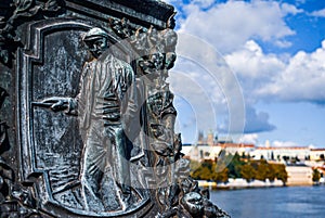 Metal plaque of a man in a hat on a Legion Bridge pillar over Vltava river in Prague, Czech Republic