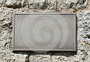 Metal Plaque on Stone Wall photo