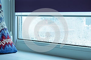 Metal-plastic window. Drops of condensation on glass in winter