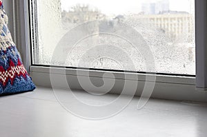Metal-plastic window. Drops of condensation on glass in winter