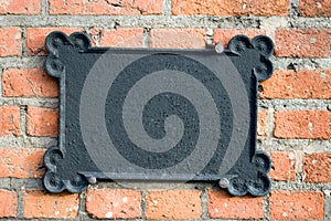 Metal plate on brick wall