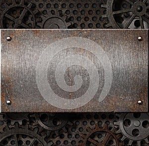 Metal plate over rusty gears background