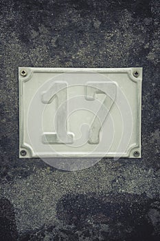 Metal plate showing house number 17