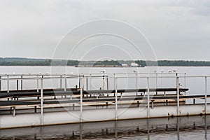 Metal platform for mooring of boats and large barge on the Volga river.
