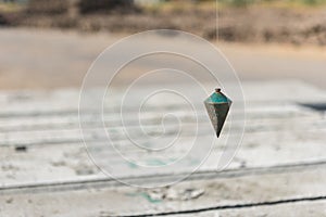 metal plumb line used in construction site