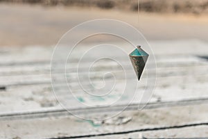 metal plumb line used in construction site